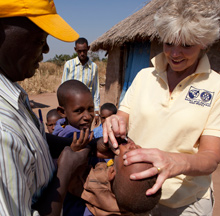 Ann Lee Hussey immunizing a child against polio in Chad.