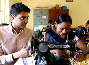 Enrico Ferro visits the vocational training center, where a women learns sewing skills.