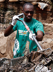 A Rotaract member clears a drainage ditch.