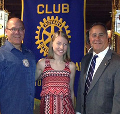 Emily Koerner with her father (left) and the past president of the club (right).